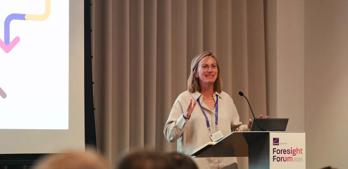 A speaker presenting at a lectern at the RAND Europe Foresight Forum 2025.